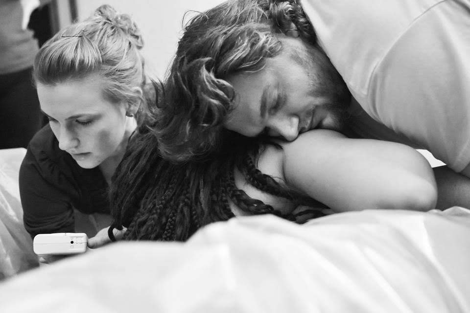 man helping his mate go through delivery